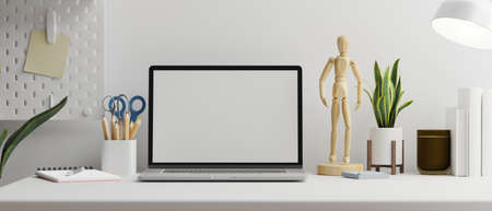 Laptop with mock-up screen on white table with stationery and supplies, 3D rendering, 3D illustrationの写真素材