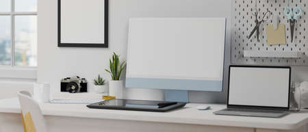 Computer and laptop with mock-up screen in minimal home office room with other supplies and decorations, 3D rendering, 3D illustrationの写真素材