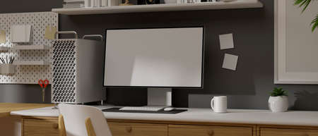 Computer monitor with mock-up screen on table with office supplies in loft working space, 3D rendering, 3D illustrationの写真素材