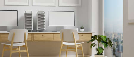 Computer devices on the desk beside the panoramic window in office building, 3D rendering, 3D illustrationの写真素材