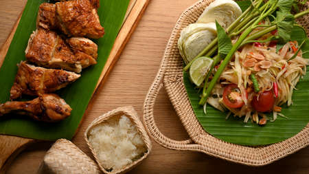 Thai food, papaya salad or Somtum with grilled chicken and sticky rice, top viewの写真素材