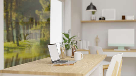 Office interior design with laptop, supplies and decorations on the table beside the picture decorated in the room, 3D rendering, 3D illustrationの写真素材