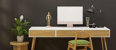 Home office desk with computer, stationery, camera and decorations in grey wall room, 3D rendering,...