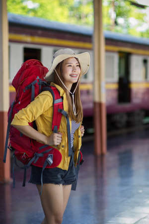 Portrait of young female backpacker smiling when arriving at her destinationの写真素材