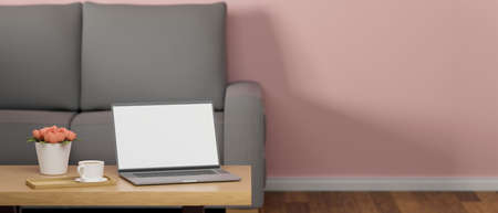 Laptop with mock-up screen on coffee table in living room with sofa, decorations and pink wall, 3D rendering, 3D illustrationの写真素材