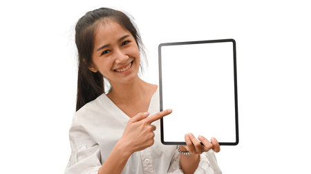 Half-length portrait of female showing digital tablet with mock-up screen isolated in white backgroundの写真素材