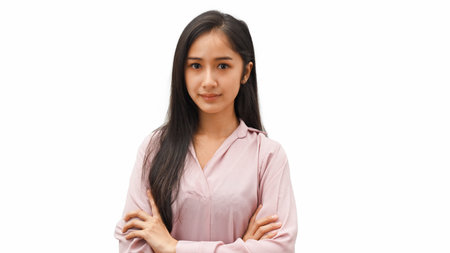 Half-length portrait of young female arm crossed standing isolated in white backgroundの写真素材