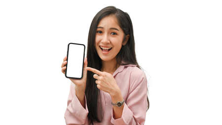 Portrait of pretty female proud to present smartphone with mock-up screen isolated in white backgroundの写真素材