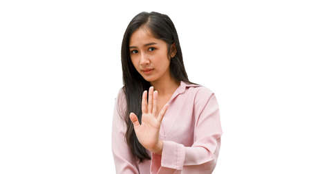 Half-length portrait of young female gesturing stop sign isolated in white backgroundの写真素材