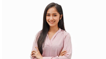 Portrait of young female arm crossed standing isolated in white backgroundの写真素材