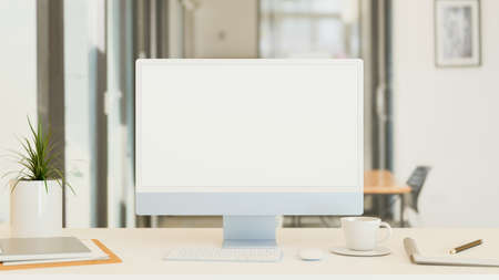Computer monitor with mock-up screen on the desk with supplies in living room, 3D rendering, 3D illustrationの写真素材