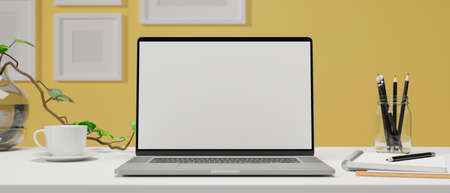 Computer laptop with mock-up screen on the table with stationery in home office room, 3D rendering, 3D illustrationの写真素材