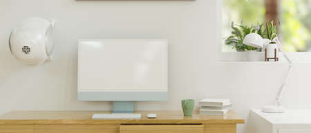 Computer monitor with mock-up screen on wooden table in home office room, 3D rendering, 3D illustrationの写真素材