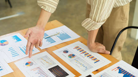 Cropped shot of businessperson explaining on business paperwork on office deskの写真素材