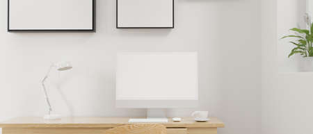 Minimal working space with computer, coffee cup, lamp and decorations, 3D rendering, 3D illustrationの写真素材