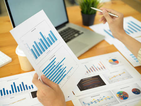 Close up view of businessperson analysing business documents in comfortable workplaceの写真素材