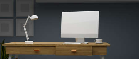 Computer with mock-up screen on wooden table with lamp in home office room at night, 3D rendering, 3D illustrationの写真素材