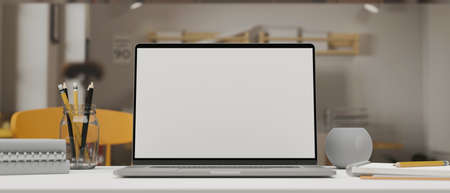 Computer laptop with mock-up screen on study table with stationery in living room, 3D rendering, 3D illustrationの写真素材
