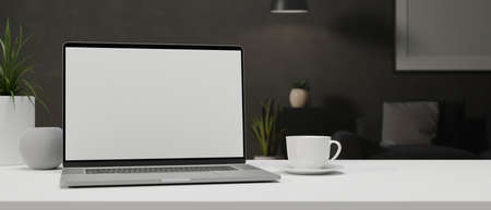 Laptop with mock-up screen on white table with a cup and decorations, 3D rendering, 3D illustrationの写真素材