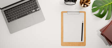 Top view of working space with laptop, clipboard, stationery and decorations, 3D rendering, 3D illustrationの写真素材