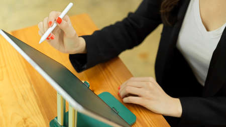 Top view of businesswoman working with digital tablet on wooden table in meeting roomの写真素材