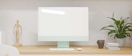 Computer monitor with mock-up screen on wooden desk with books and decorations, 3D rendering, 3D illustrationの写真素材