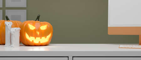 Pumpkin lamp and halloween decorations decorated on computer desk, 3D rendering, 3D illustrationの写真素材