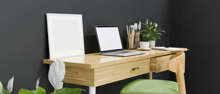 Side view of artist workspace with laptop, paint tools and decorations in loft home office roomの写真素材