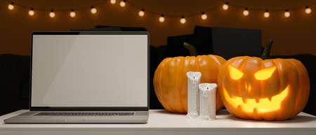 Laptop with mock-up screen on the table with pumpkin lamps and candle decorated in halloween concept, 3D rendering, 3D illustrationの写真素材