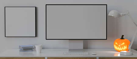 Computer device with mock-up screen on the desk decorated with pumpkin lamp, 3D rendering, 3D illustrationの写真素材