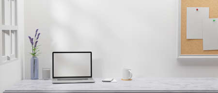 Minimal working space with laptop, smartphone, flower vase and notice board in the room, 3D rendering, 3D illustrationの写真素材