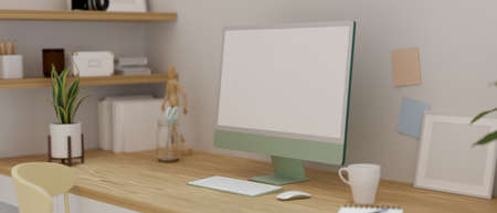 Computer device on the table in home working space decorated with frames, plant pot and stuff, 3D rendering, 3D illustrationの写真素材