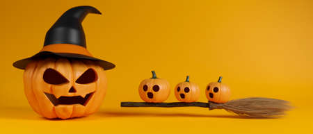 Halloween grinning pumpkins with witch hat and broomの写真素材