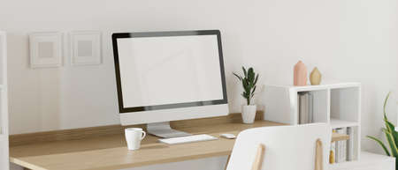 Computer device with mock-up screen on the table in home working space with decorations and bookshelf, 3D rendering, 3D illustrationの写真素材