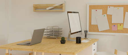 Desktop computer with mock-up screen on the wooden desk with stationery and camera in loft office room, 3D rendering, 3D illustrationの写真素材