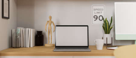 Home working space with laptop, computer, books and decorations on the desk, 3D rendering 3D illustrationの写真素材