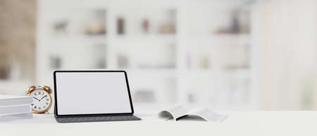 Digital tablet with mock-up screen and keyboard on the table with books and blurred background, 3D rendering, 3D illustrationの写真素材