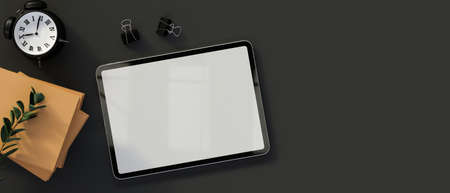 Top view of digital tablet with mock-up screen on dark table with supplies and copy space, 3D rendering, 3D illustrationの写真素材