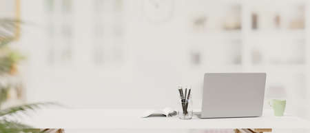 Laptop, stationery and copy space on the table with blur background, 3D rendering, 3D illustrationの写真素材