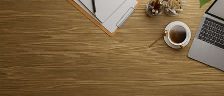 Top view of wooden table with laptop, coffee up and stationery, 3D rendering, 3D illustrationの写真素材