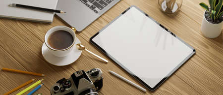 Cropped shot of study table with mock up tablet with stationery on wooden table, 3D rendering, 3D illustrationの写真素材