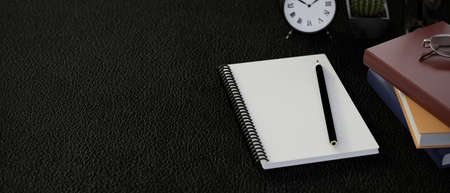 Top view of dark modern workspace with blank notebook and office suppliesの写真素材