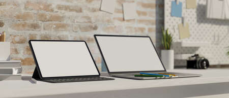 Modern work space with laptop and tablet, stationary on the white desk, shelf on brick loft wall 3D rendering, 3D illustrationの写真素材