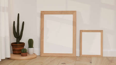 Minimal decoration design, Blank picture frames on the wooden floor with minimal cactus and white wallpaper. 3D rendering, 3D illustrationの写真素材