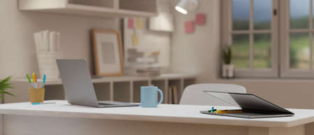 Cropped shot of portable workspace with laptop on light wooden table, stationary and decorations in cozy office room. 3D rendering, 3D illustrationの写真素材