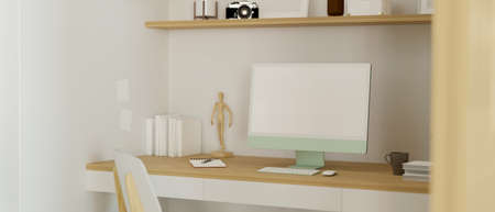 Computer with blank screen monitor in cozy Japanese working space designed with figure, camera, shelf and books on minimal wooden desk, 3D rendering, 3D illustrationの写真素材