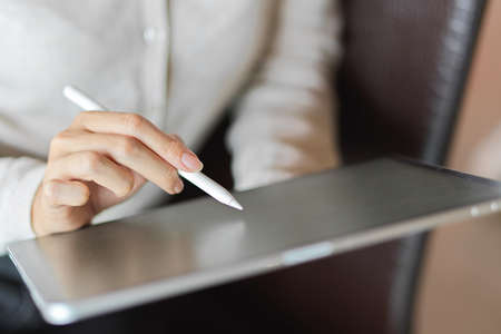 Close up of female using tablet, suit for business or study contentの写真素材