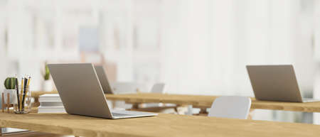 Modern study room designed with laptop on the wooden table, stationary, and blurred background, back to school, 3D rendering, 3D illustrationの写真素材