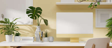 Cozy light yellow working space design with computer monitor, minimal plants, modern decoration on the white desk. 3D rendering, 3D illustrationの写真素材