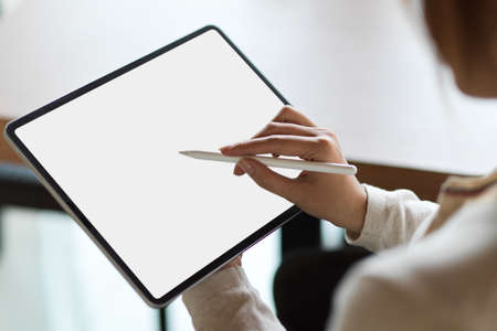 Close up a businesswoman using tablet with stylus penの写真素材
